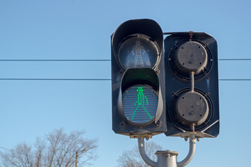 Black two-section traffic light that looks both ways, installed at crossing of railway tracks in...
