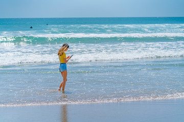 Teenage girl standing on beach