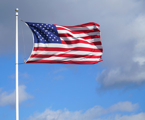 waving USA flag on pole in sunny day