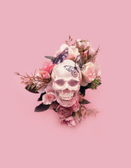 skull with flowers and butterflies on pink background. creative concept. magic surreal image....