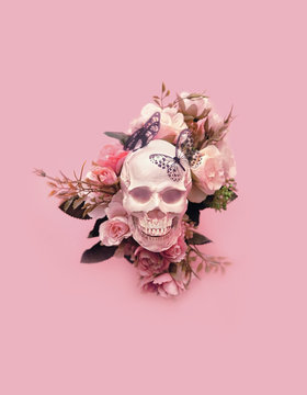 skull with flowers and butterflies on pink background. creative concept. magic surreal image. atmosphere  witch ritual