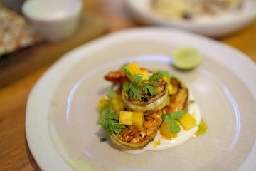 Grilled Chipotle Prawns with mango salsa, smoked yogurt, basil oil, parsley and lemon.