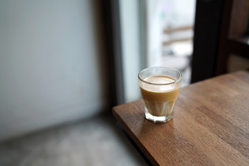 Dirty Coffee - A glass of espresso shot mixed with cold fresh milk on blurred background and copy space, Perfect drink for summer time.