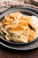 Boiled pierogi (Polish dumplings) stuffed with cabbage and mushrooms