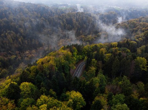 Moody aerial view of a mountain road winding through the woods in Bavaria, Germany
