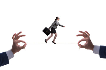 Businesswoman walking on tight rope