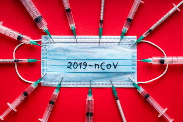2019-nCoV - Coronavirus , WUHAN virus concept. Surgical mask protective mask on red background with...