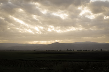 A beautifel panoramic photo of sunrise on the vally. Dramatic clouds. The sun rays.