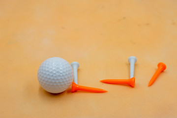 Golf ball on orange background