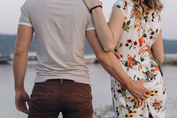 A man in a gray shirt grabbed a woman by the buttock.