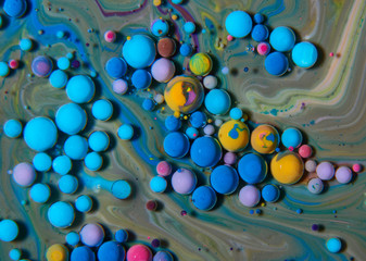 Macro photography of colorful bubbles on some fluids that seems to be some kind of unknown worlds.