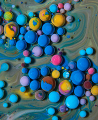 Macro photography of colorful bubbles on some fluids that seems to be some kind of unknown worlds.