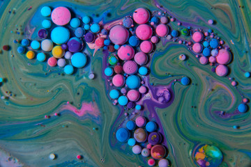 Obraz na płótnie Canvas Macro photography of colorful bubbles on some fluids that seems to be some kind of unknown worlds.