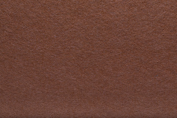 Velvet texture of brown woolen felt. matte background of suede fabric, close up