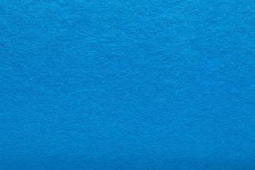 Fine grain blue woolen felt. Texture background. Velvet scarlet matte background of suede fabric