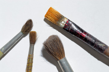 old paint brushes on a white background.