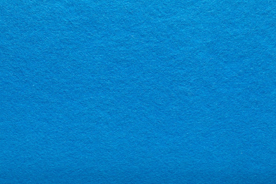 Fine grain blue woolen felt. Texture background. Velvet scarlet matte background of suede fabric