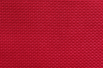 fabric with abstract pattern. red fiber texture polyester close-up. fine grain felt fabric background