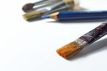 old paint brushes on a white background.