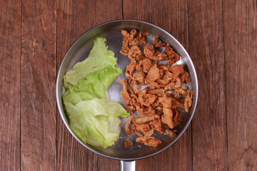 Fried chicken skin on wood table.
