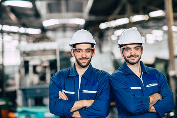 Engineering team portrait smile in heavy industry factory men working together. Arm Crossed fold with space.