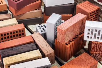 clinker, silicate, ceramic and other types of bricks of different colors. The background is of a different brick