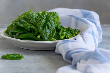 Close up view of raw spinach salad, vegetarian healthy ingredient
