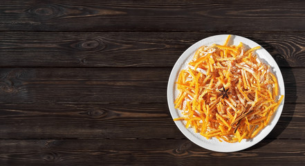 Image of homemade candied oranges peel on the dark wooden table. Top view, copy space