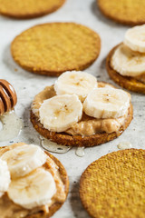 Crispbread with peanut butter, banana and honey. Vegan food concept.