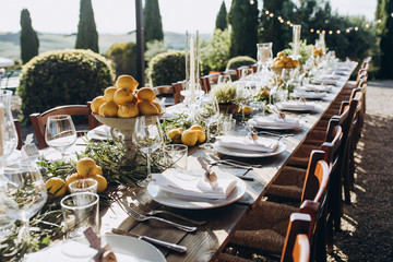 in the back yard of the old villa there is a long festive table, which is decorated with lemons and...