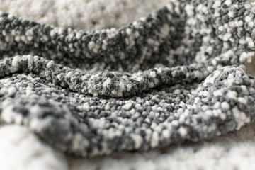 Fine textured and voluminous fabric in white and gray. Embossed textile pattern, pleasant to the...
