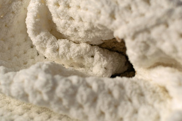 Fine textured and voluminous fabric in white and gray. Embossed textile pattern, pleasant to the touch and delicate, velvety and textured background for design and decoration.