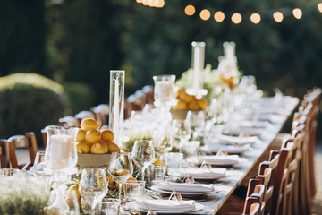 in the back yard of the old villa there is a long festive table, which is decorated with lemons and...