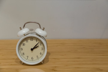 Alarm clock on the wood table beside the bed