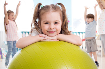 Sporty kid with children group having fun in gym - 322245076