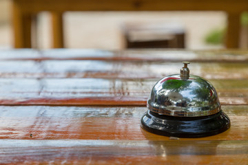 Bell on the wood table in restaurant with nature