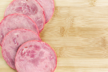Slices of sliced ham on the kitchen Board close up. Copy space.