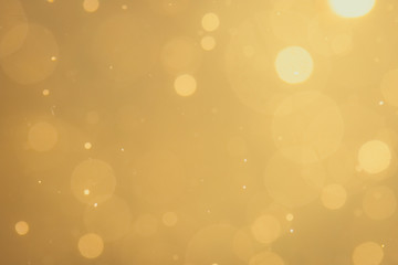 Dark Abstract Gold bokeh sparkle on black background