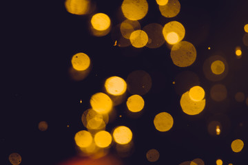 Dark Abstract Gold bokeh sparkle on black background