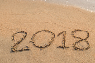 2018 message written in the sand at the beach