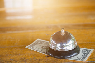 Bell on the table with money