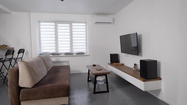 interior of studio apartment with new repair in white and grey colors, cozy and minimalistic flat