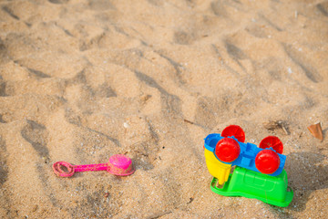 Fototapeta na wymiar Colourful Toy car on the sand beach