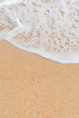 Wave of the sea on the sandy beach