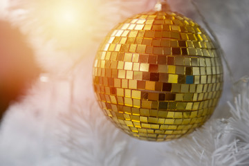 Golden Ball on White Christmas Tree