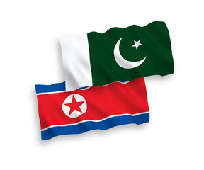 National vector fabric wave flags of North Korea and Pakistan isolated on white background. 1 to 2 proportion.