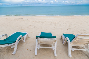 Fototapeta na wymiar Rows of sun bed at sand beach for relaxing with tropical beach and sea