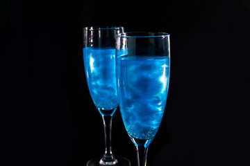 two glasses with blue sparkling champagne