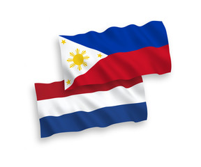 National vector fabric wave flags of Philippines and Netherlands isolated on white background. 1 to 2 proportion.