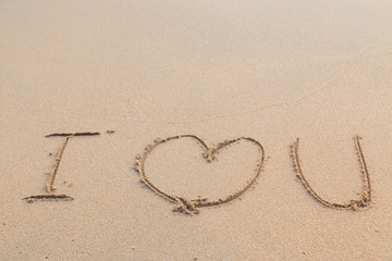 Obraz na płótnie Canvas Message i love you on the sand beach